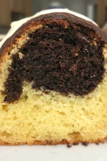 Slice of Fiddler on the Roof Cake from The Cake Mix Doctor showing chocolate and vanilla batters and marshmallow icing.