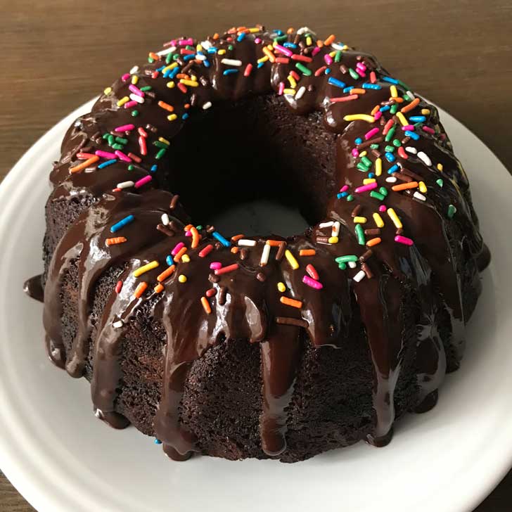 A chocolate cake mix Bundt cake sitting on a white plate.