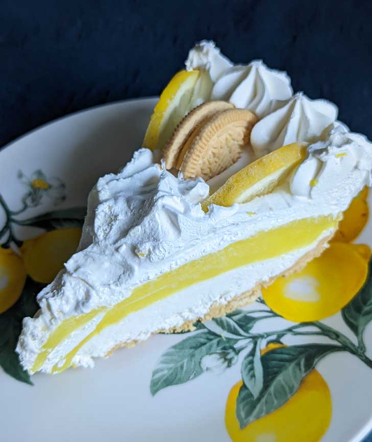 Slice of a Lemon Oreo Cookies and Cream Pie on a plate.