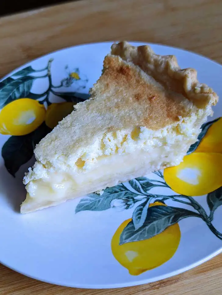 Lemon Cake Pie on a plate decorated with lemons.