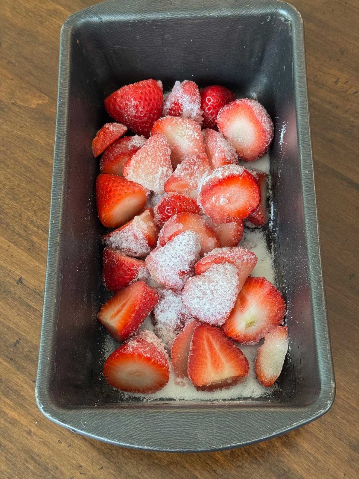 Roasting strawberries in a loaf pan to make a sweet strawberry syrup for ice cream.