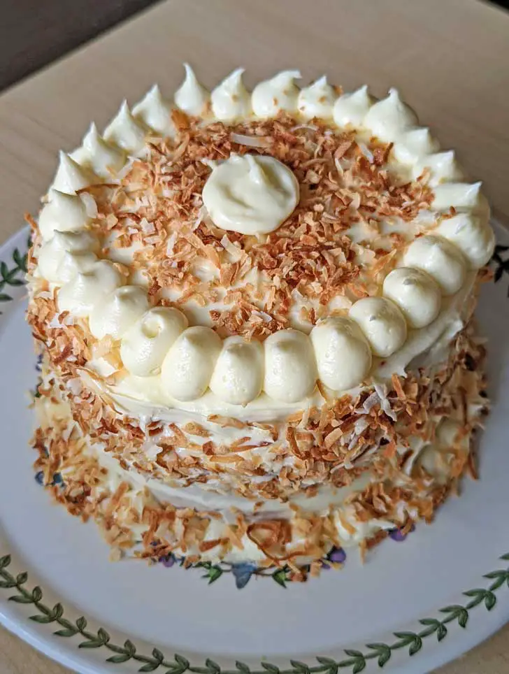 A 6-inch coconut cake with cream cheese icing and lots of toasted coconut.