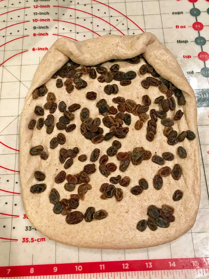 Raisins on dough before rolling