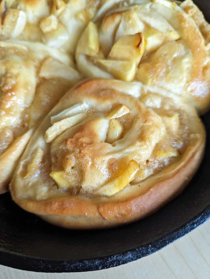 Small batch of Apple Pie Cinnamon Rolls in a cast iron skillet.