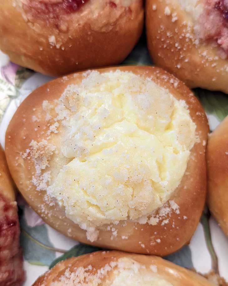 Potato Flour Kolaches with cream cheese filling and cherry preserves on a plate.