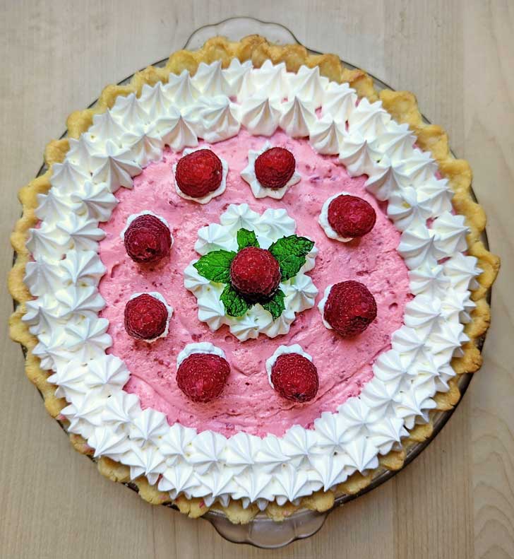 Raspberry Chiffon Pie with a gluten-free pie crust in a glass pie dish.