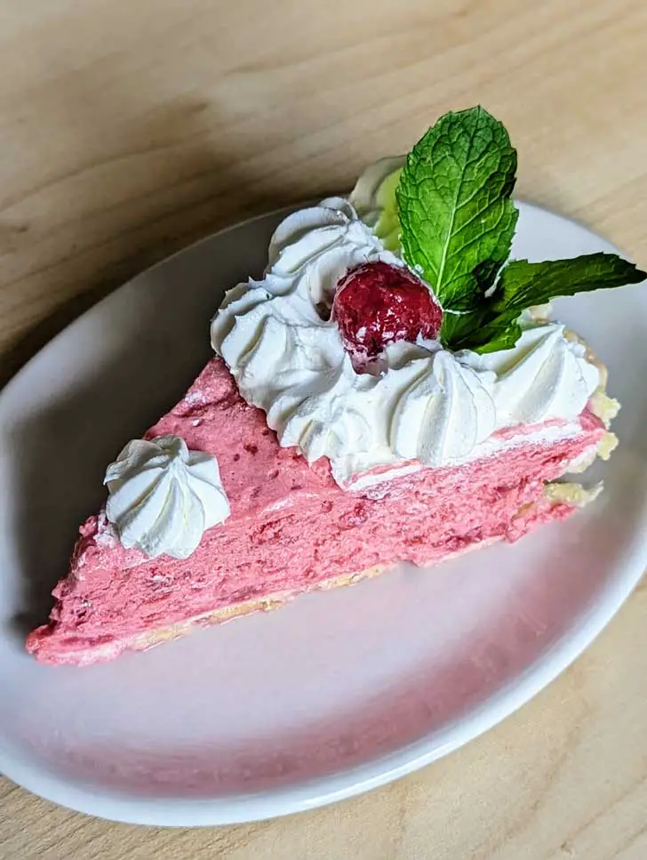 Slice of Raspberry Chiffon Pie on a Fishs Eddy Here's Your Snack plate.