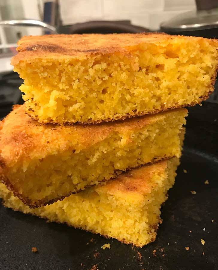 Low Country Cornbread recipe with no sugar and no flour baked in a cast iron skillet.