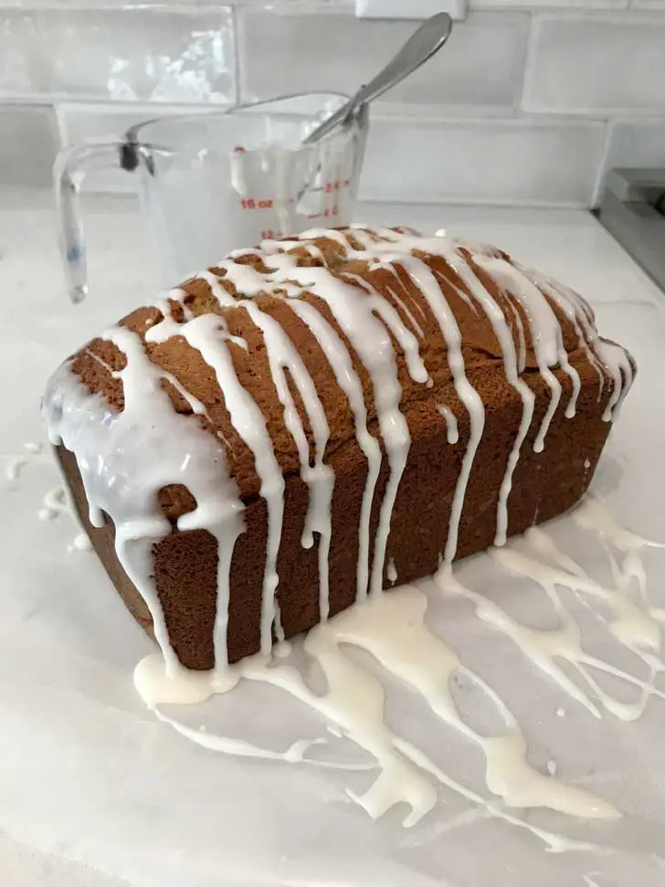 Apple Bread loaf with an opaque white icing.