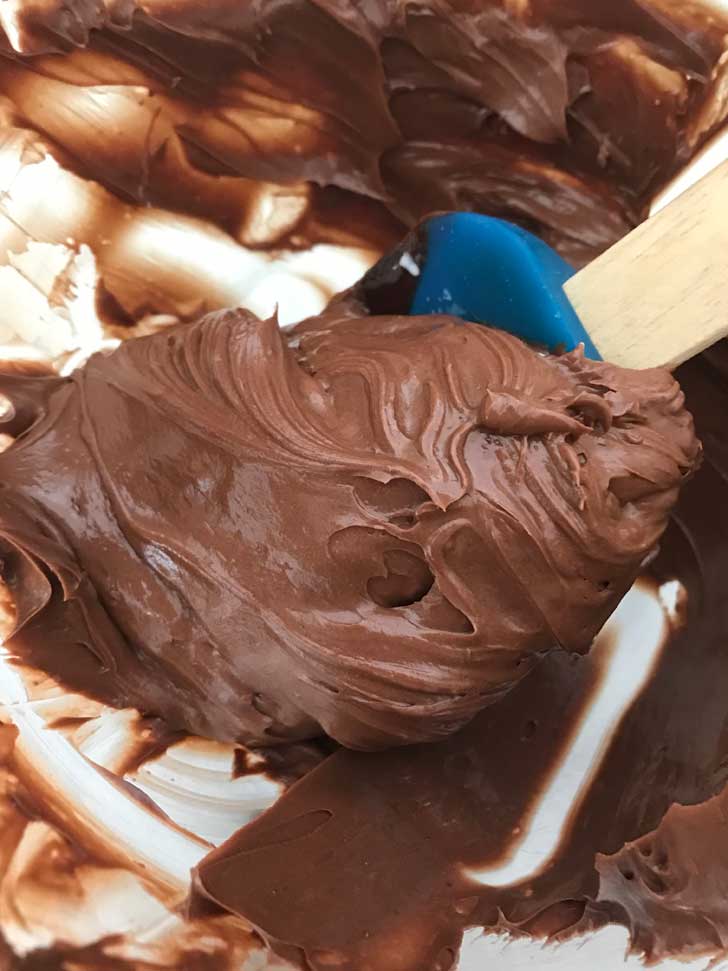 No Egg Chocolate Buttercream Frosting on a blue scraper