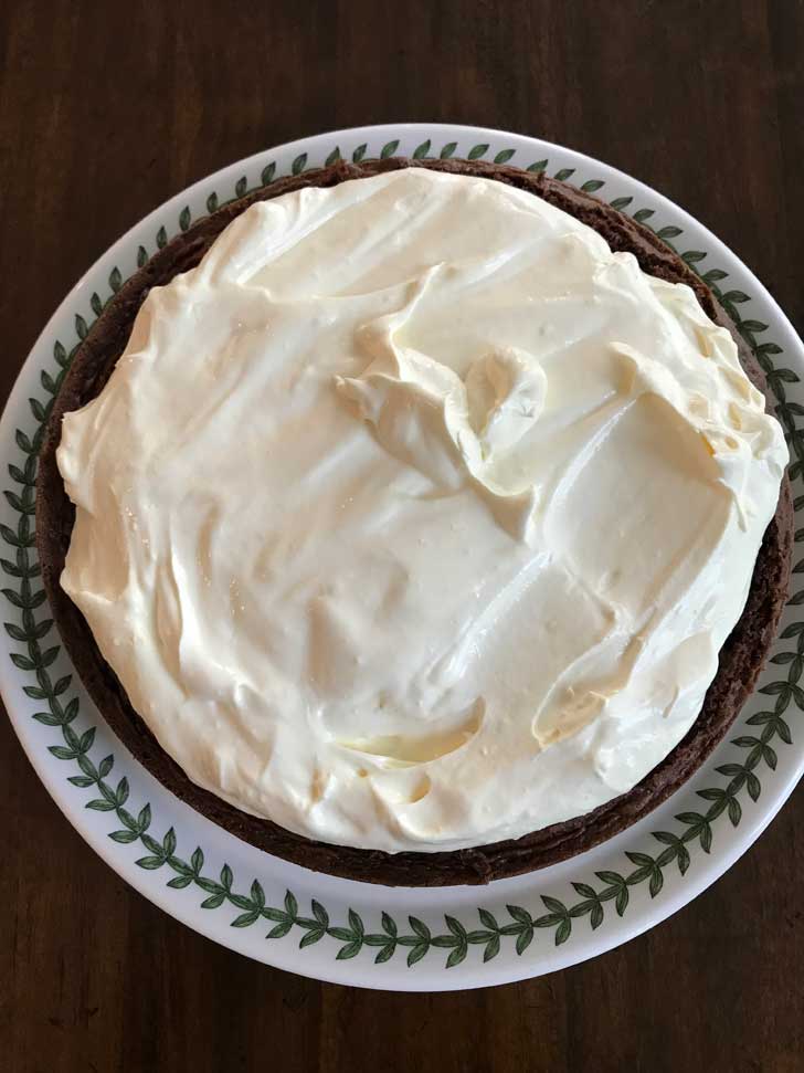 Bavarian Cream Filling on top of a split chocolate cake.