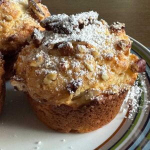 Pineapple Yogurt Muffins recipe topped with chopped pecans and powdered sugar