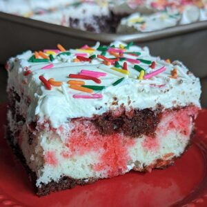 Neapolitan Poke Cake recipe that starts with cake mix, has gelatin stripes and a pudding mix frosting.