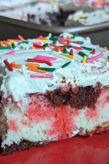 Neapolitan Poke Cake recipe that starts with cake mix, has gelatin stripes and a pudding mix frosting.