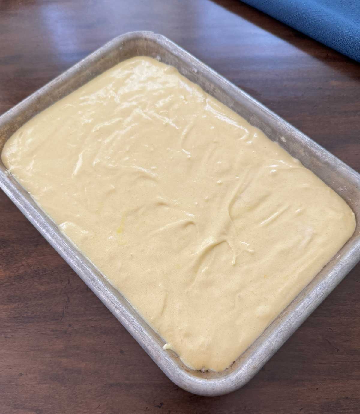 Lemon Cake Batter in a ⅛ sheet pan.