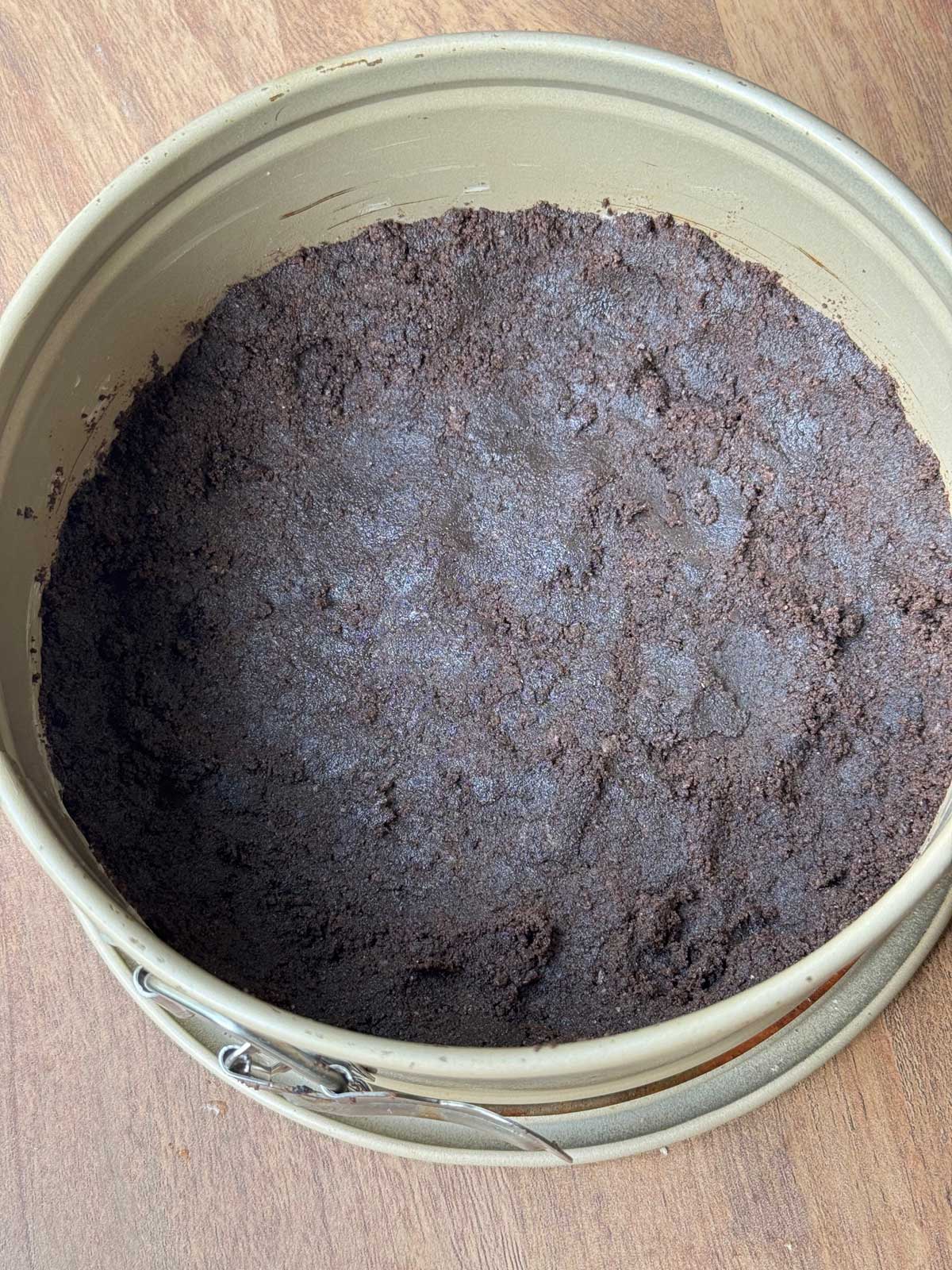 An Oreo crust made with 12 Oreos and 2 tablespoons of butter in a 7-inch round springform pan.