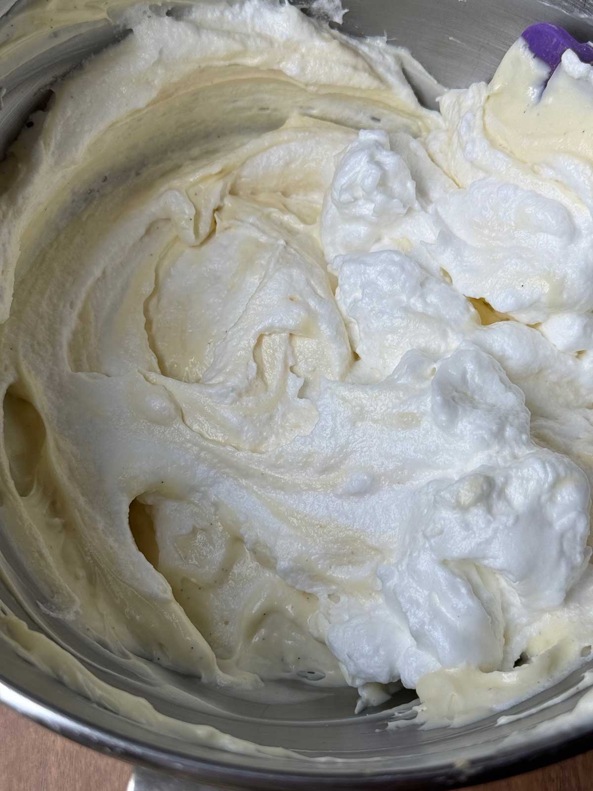 The filling for an Oreo cheesecake with whipped egg whites being folded in.