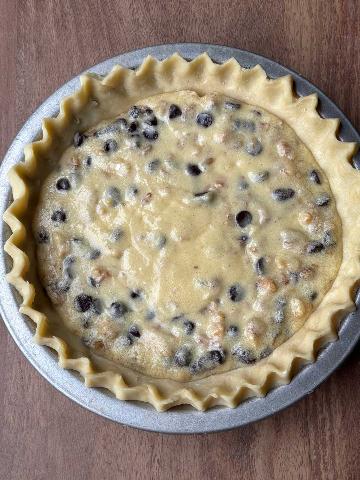 Unbaked Kentucky Derby Pie in a cream cheese and butter crust.