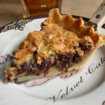 Sliced Kentucky Derby day pie on a plate with recipe.