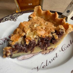 Sliced Kentucky Derby day pie on a plate with recipe.