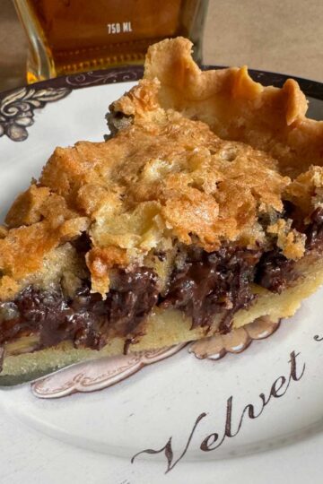 Sliced Kentucky Derby day pie on a plate with recipe.