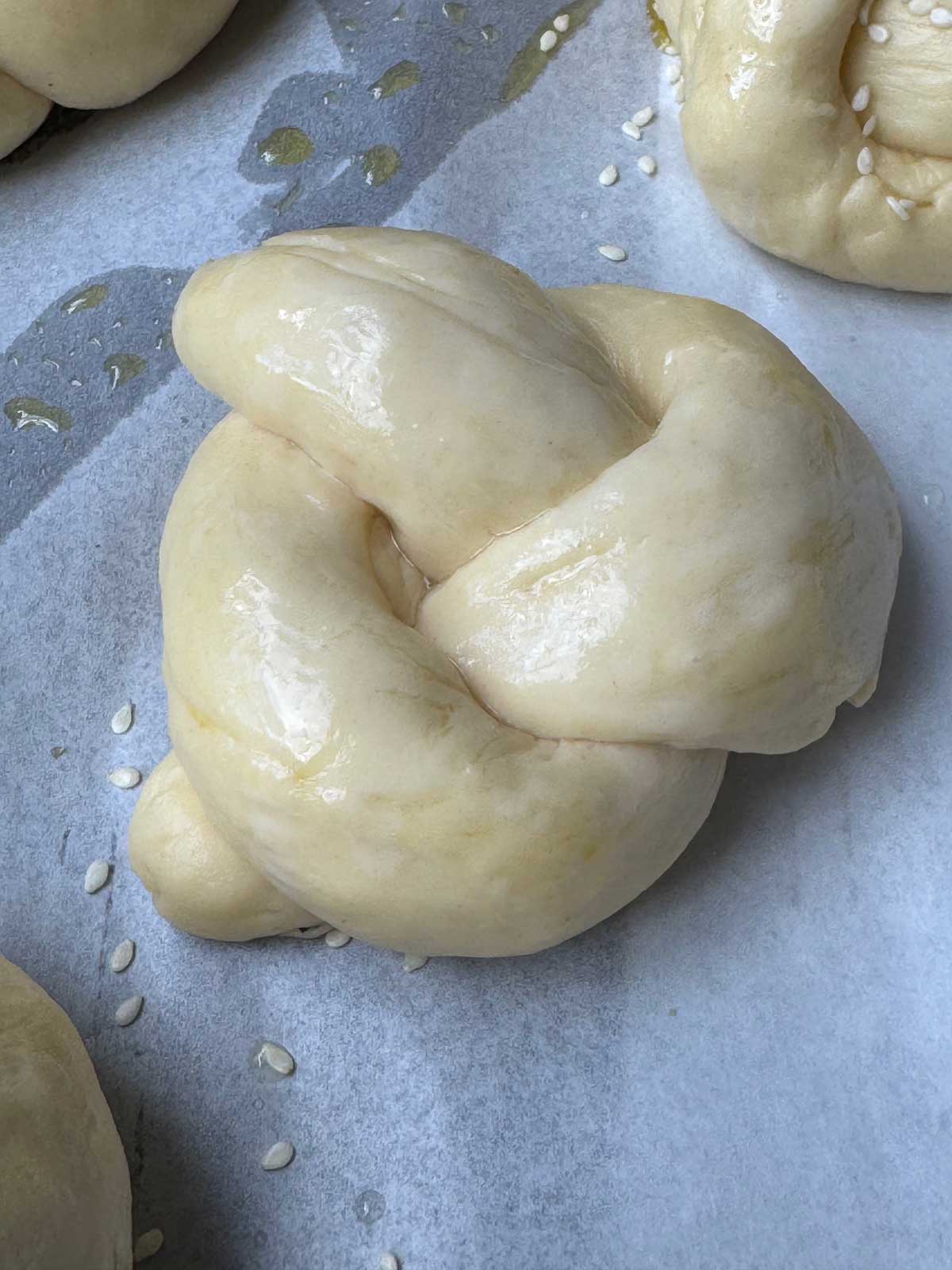 Egg Knot Roll dough brushed with egg white and ready to bake.