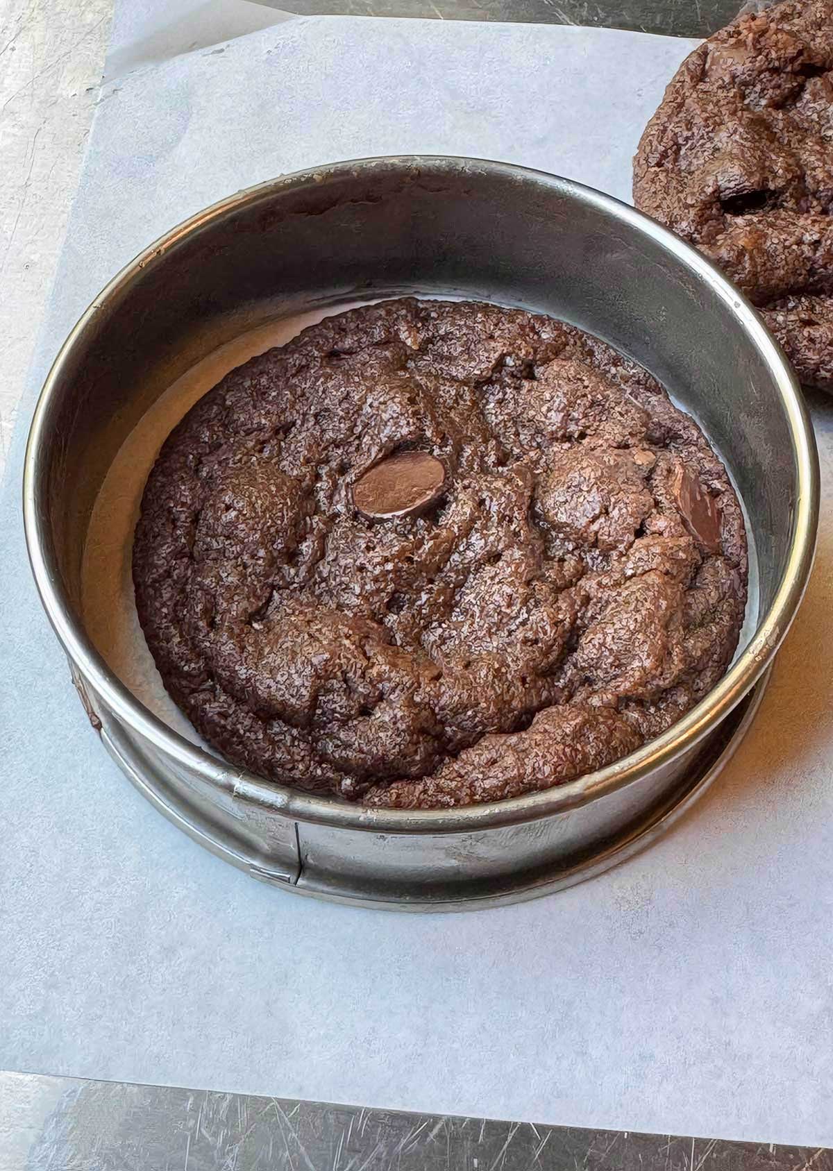 Chewy Vegan Double Chocolate Cookies being rounded using the cookie rounding trick with an English muffin ring.