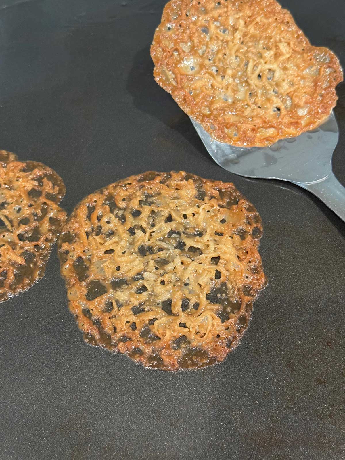 Lace cookies baked on an insulated sheet pan without parchment paper.