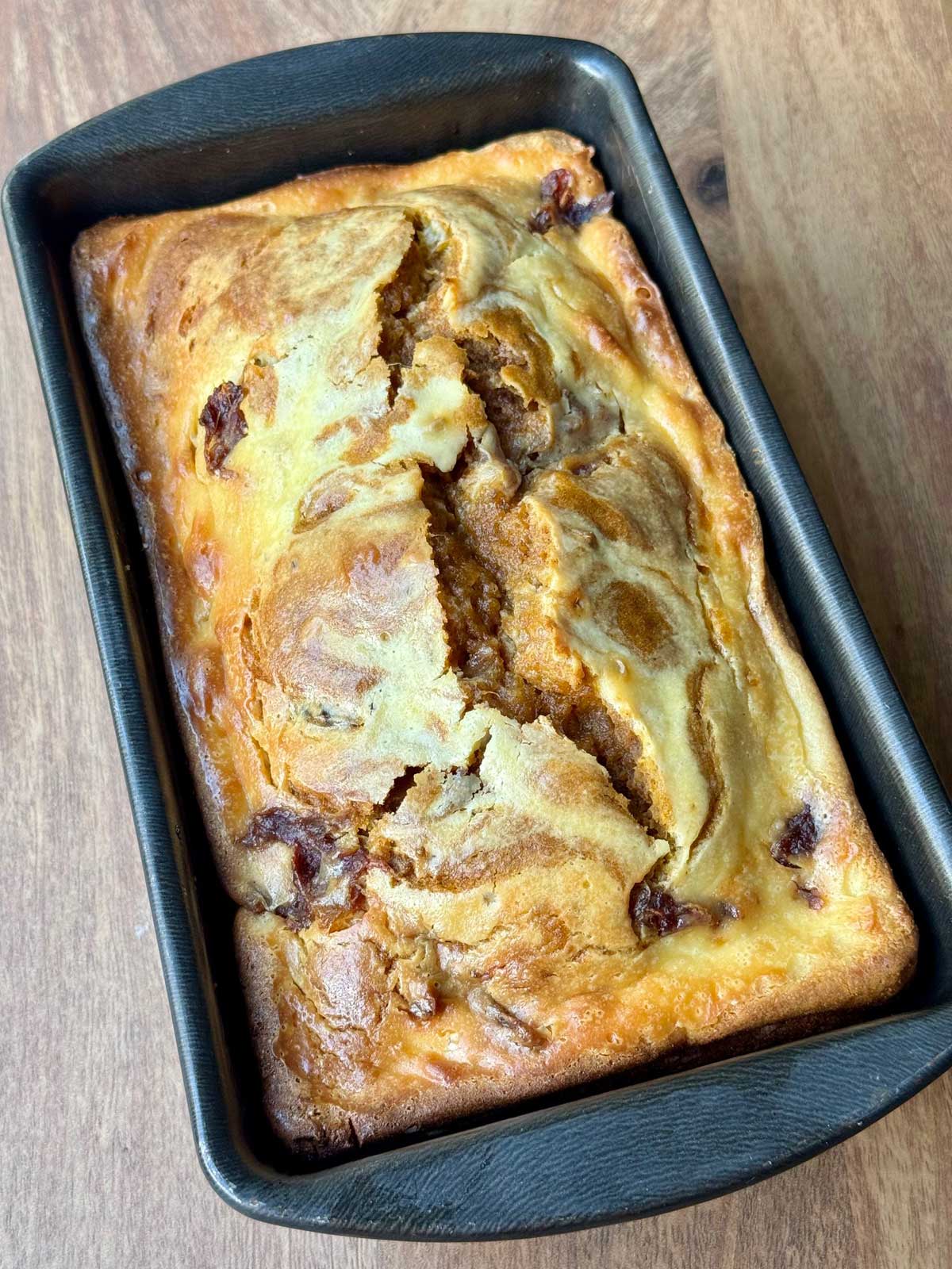 Pumpkin Date Cream Cheese Swirl Bread recipe baked in a 9x5 inch loaf pan.