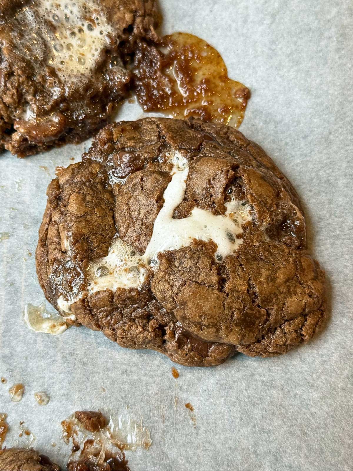 Espresso Marshmallow Cookies spreading on parchment paper.