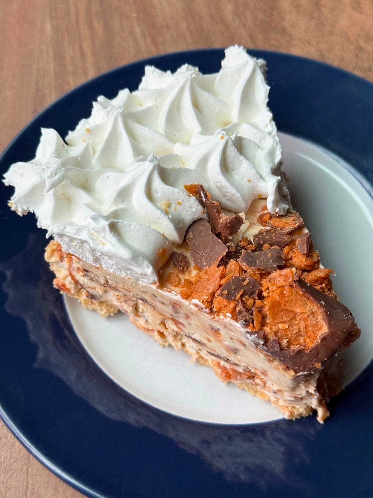 Slice of Butterfinger Pie in a brown butter Ritz cracker crust.