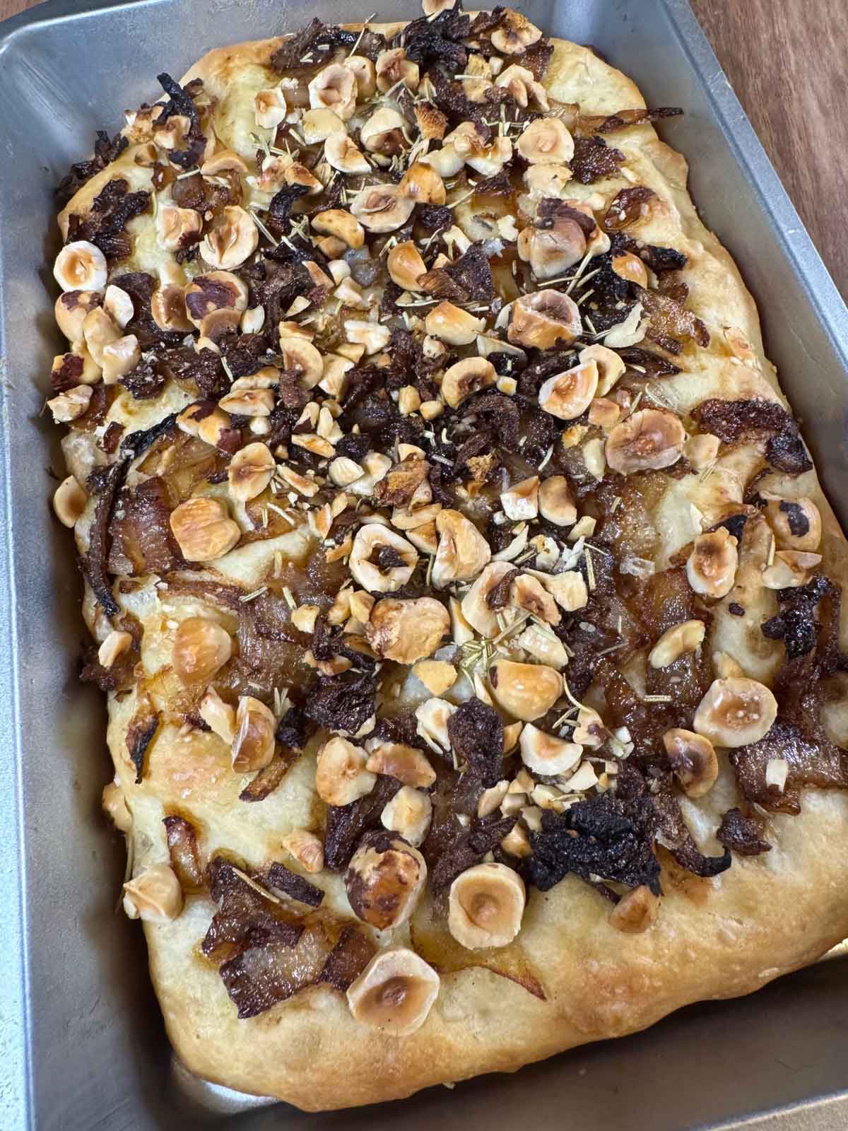 Focaccia topped with hazelnuts and caramelized onions.