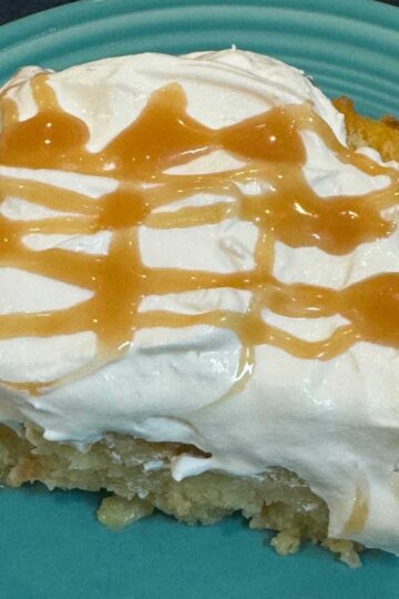Menehune Bread Pudding topped with whipped cream and caramel sauce.