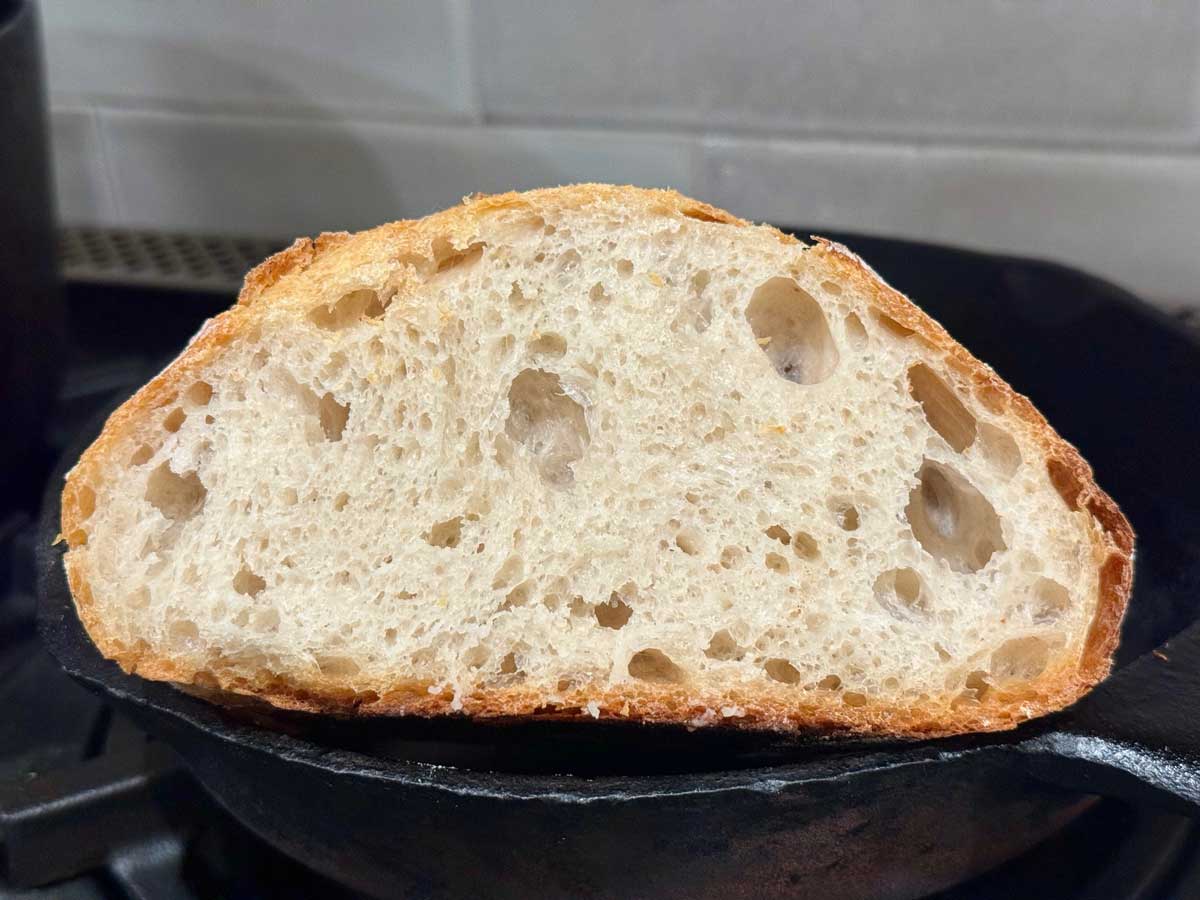 Basic sourdough bread recipe made without yeast. Cut to show air bubbles.
