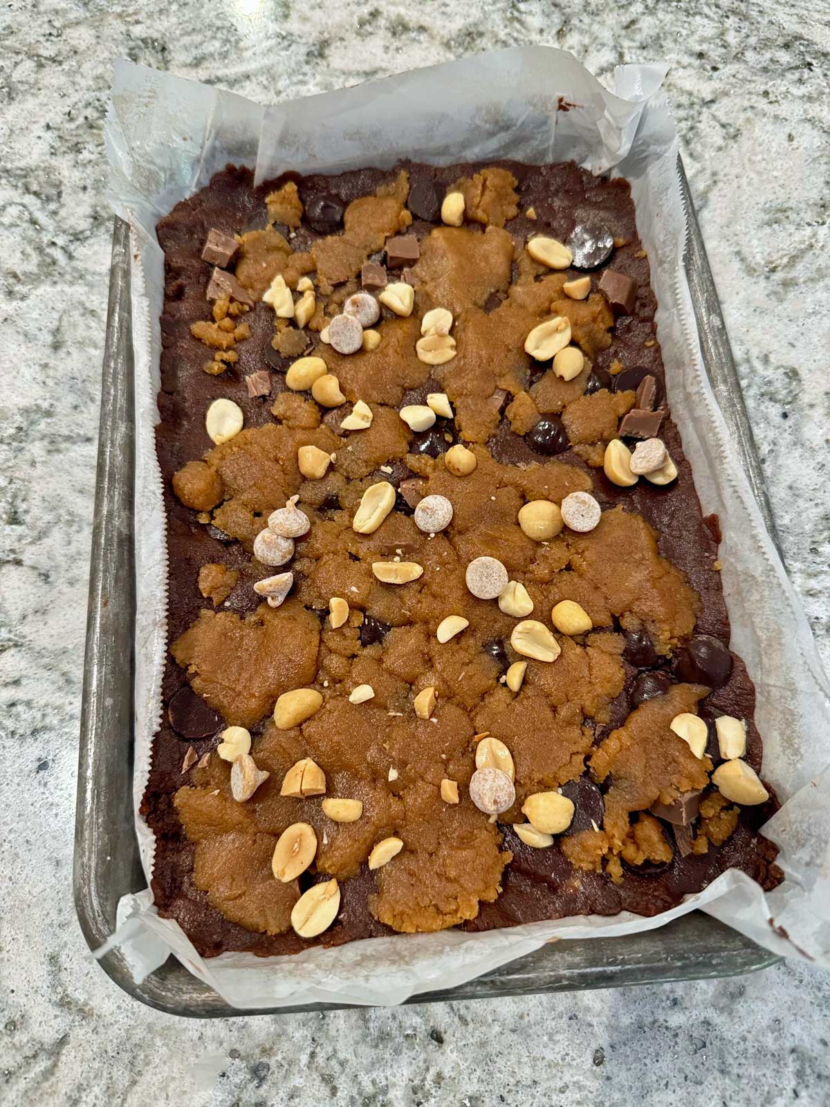 Unbaked flourless chocolate peanut butter bars in a mini sheet pan.