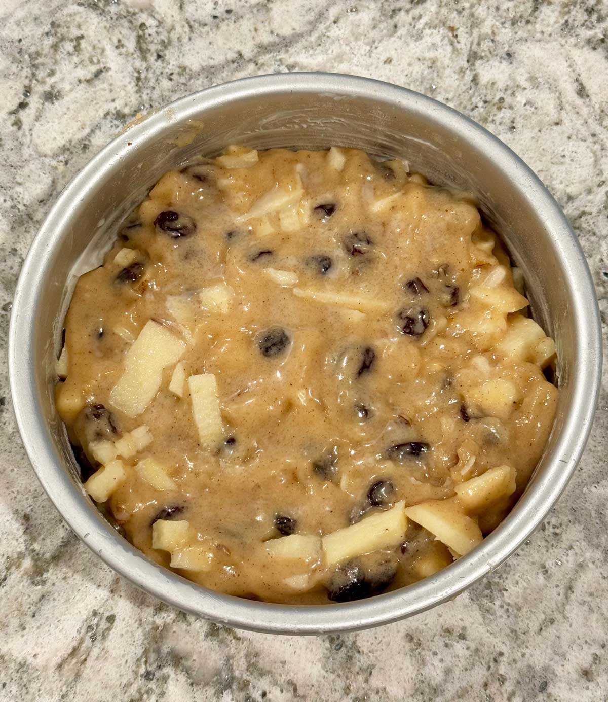 Amazin' Raisin Cake batter in the pan showing thickness.