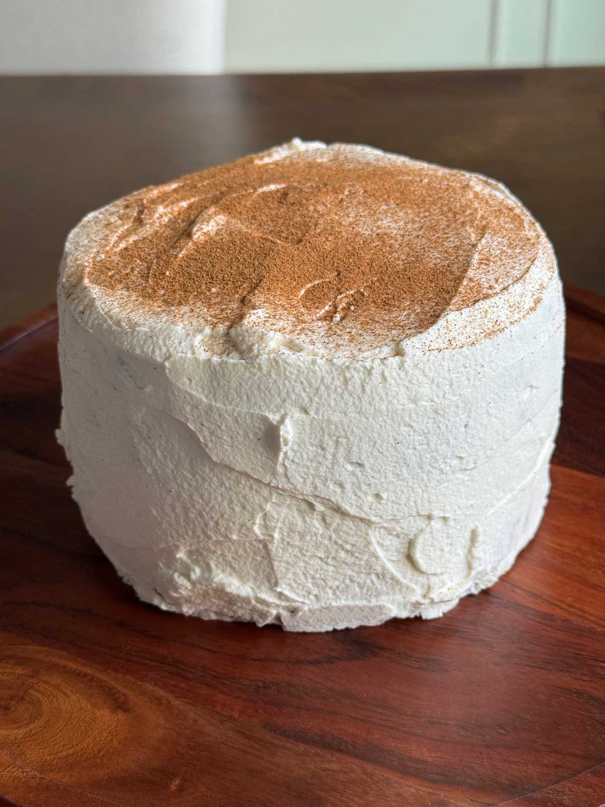Amazin' Raisin Cake frosted with whipped cream and cinnamon.