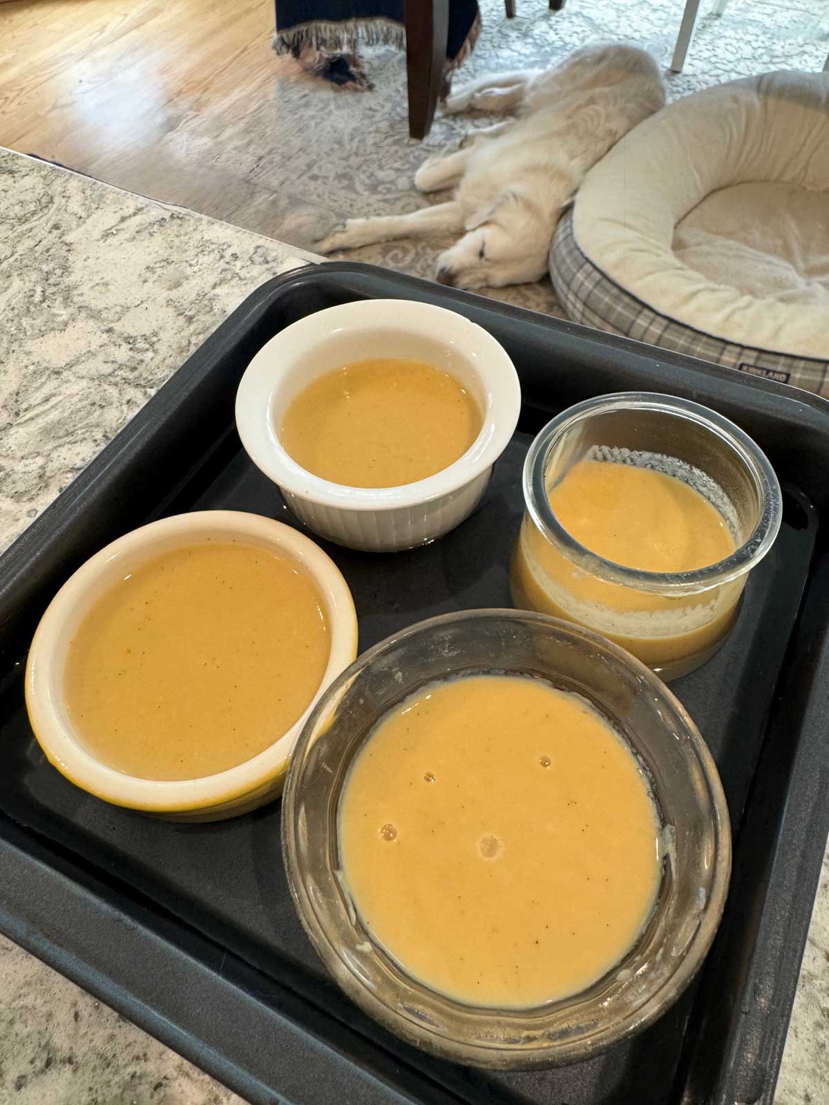 Individual maple custards in a metal pan filled ⅔ of the way with water.