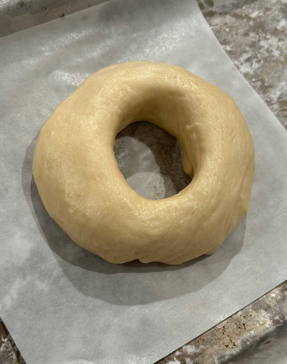 Shaped bagel dough ready to be boiled.