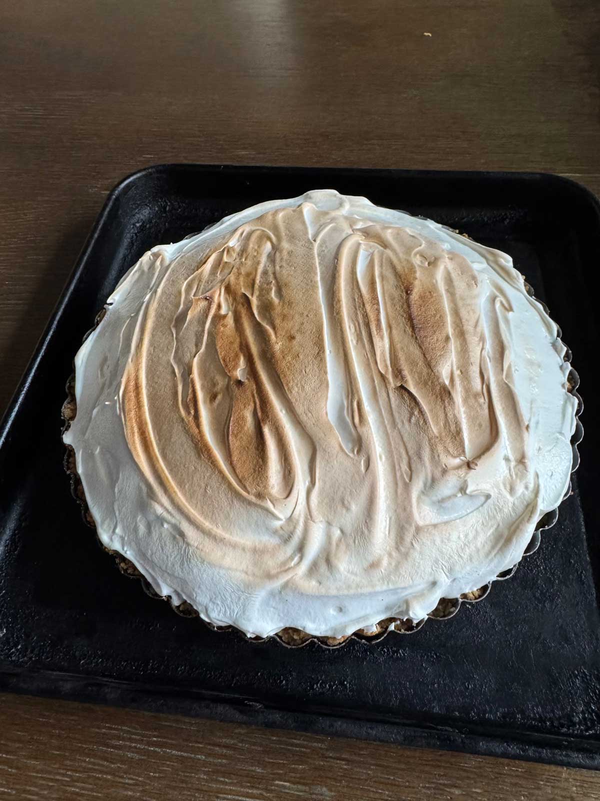 S'mores Tart straight out of the broiler with a light brown topping.