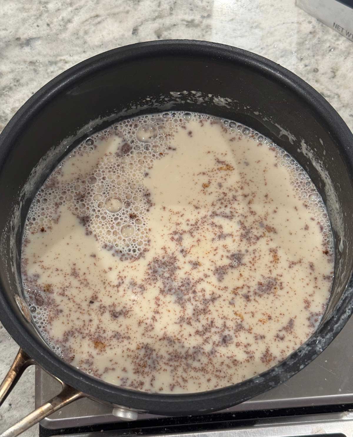 Lumpy undissolved cinnamon in cinnamon ice cream base.