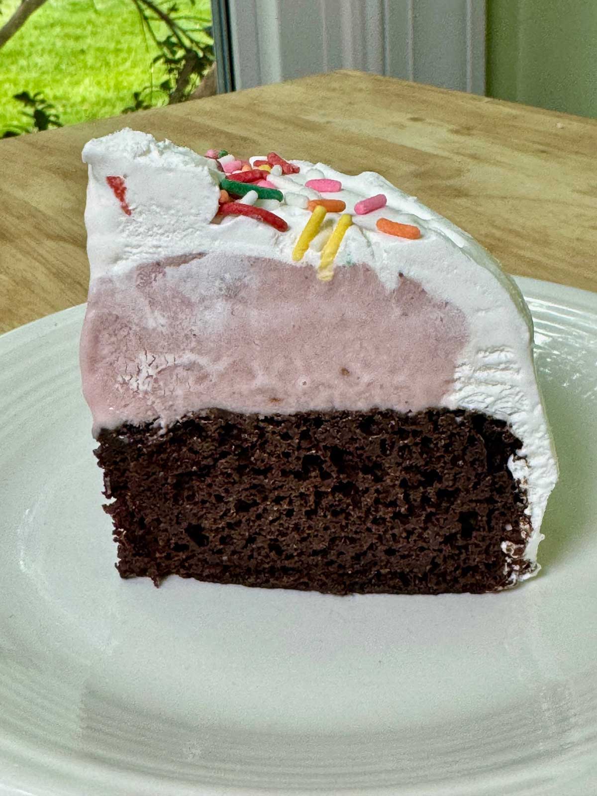 Six Inch Ice Cream Cake slice with a layer of chocolate cake and strawberry ice cream.
