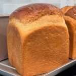 A cube shaped loaf of sourdough discard bread made without eggs.