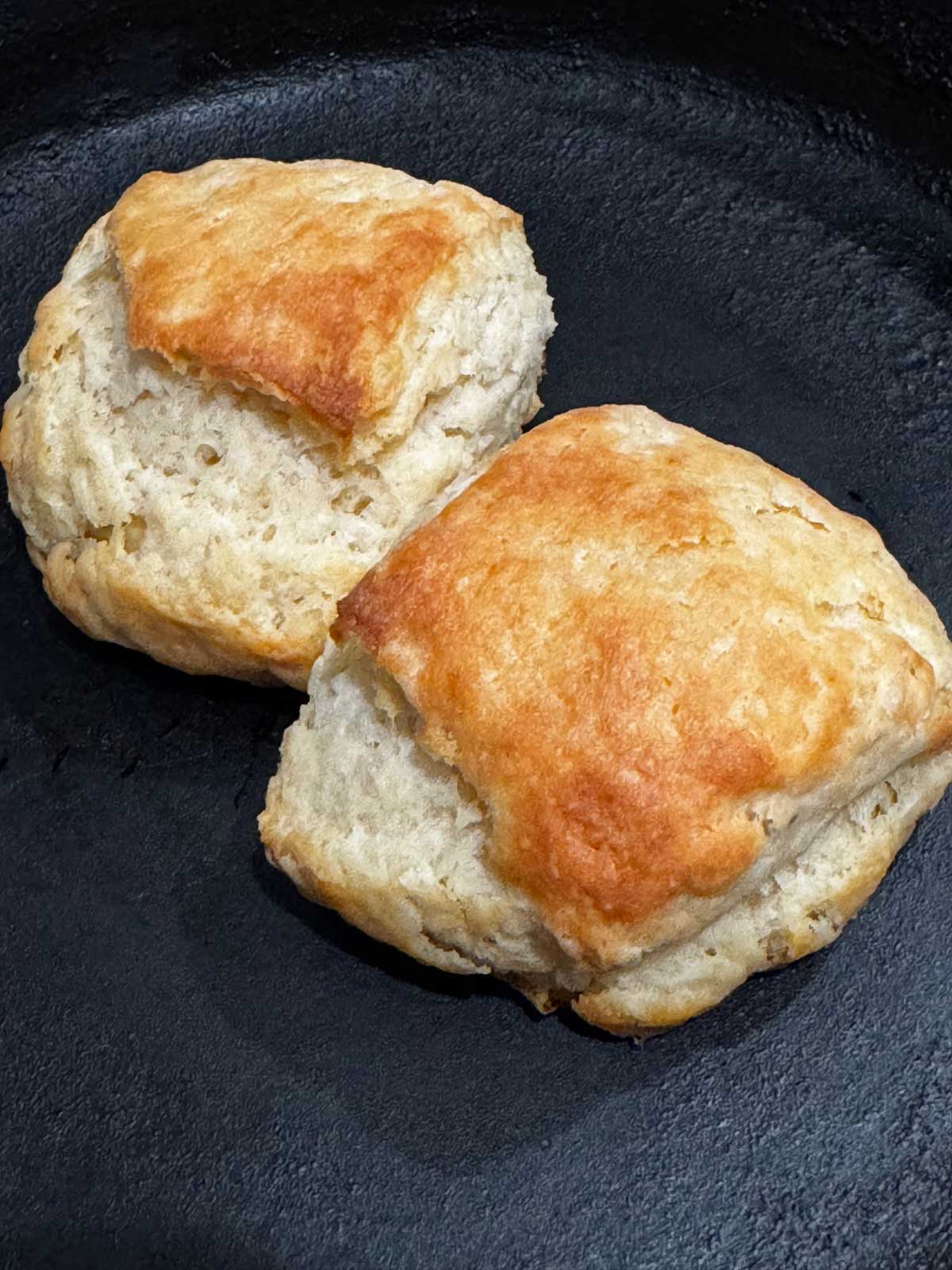Two golden brown buttery square shaped biscuits to be used for strawberry shortcake.