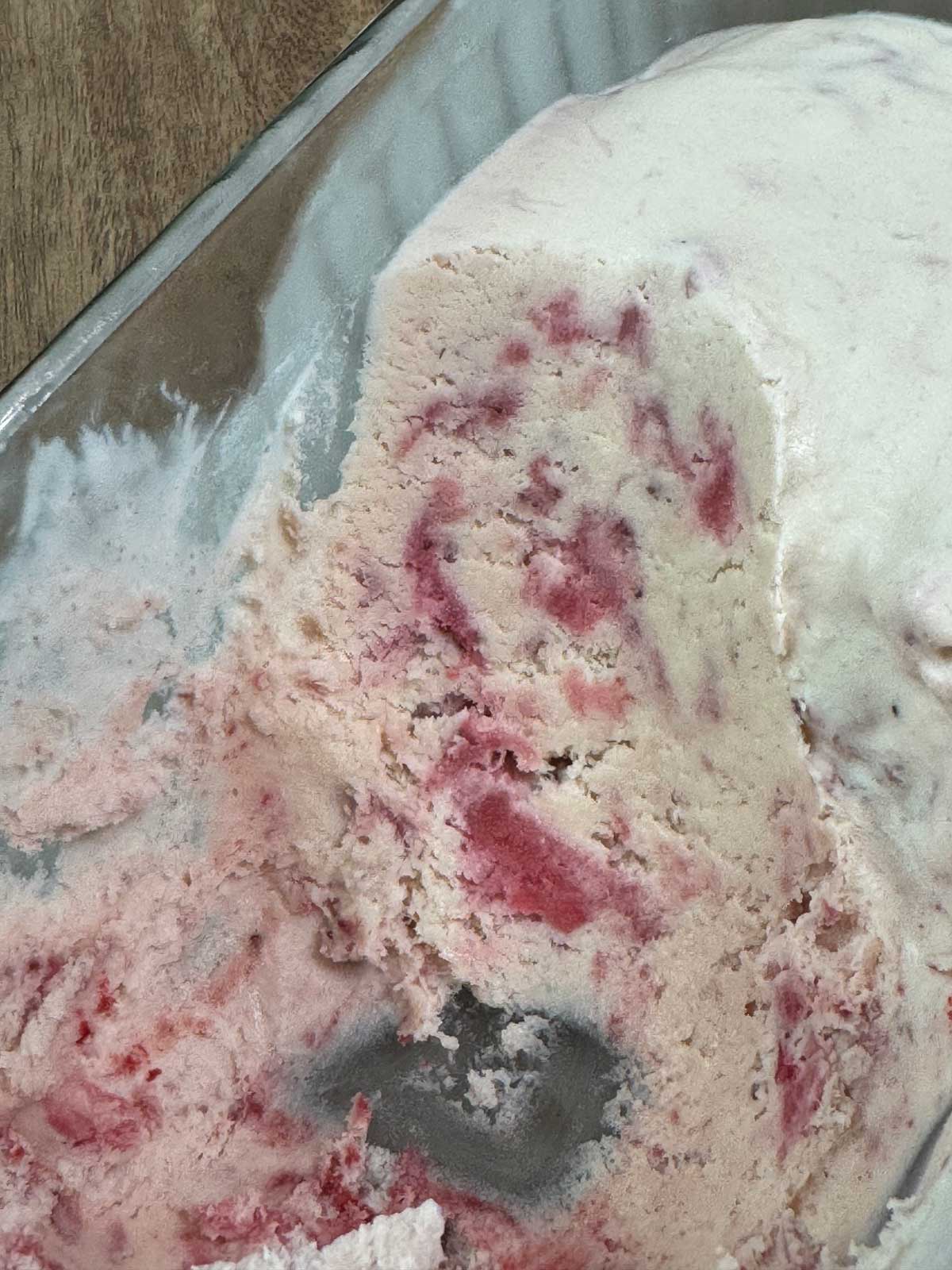 Easy no churn strawberry ice cream scooped to show texture.