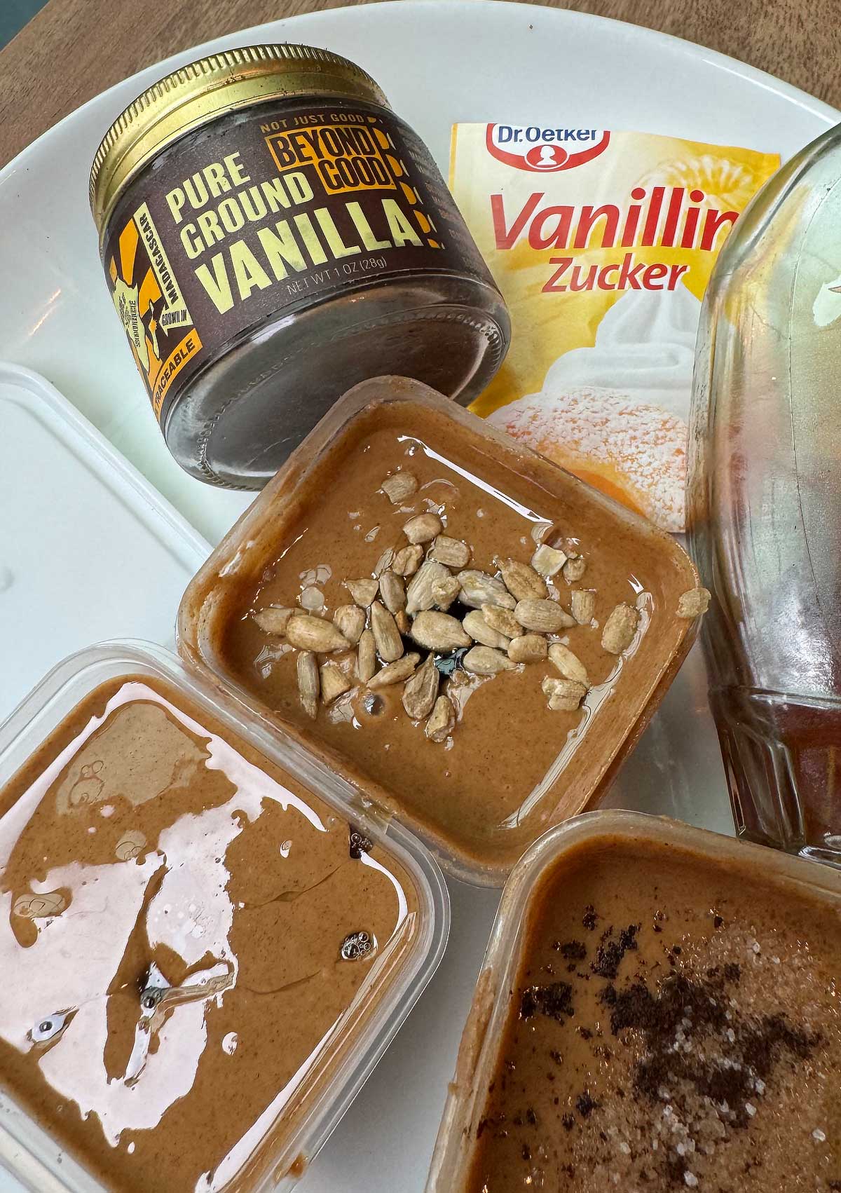 Flavoring mixed nut butter with vanilla bean powder, vanilla sugar, honey and maple syrup.