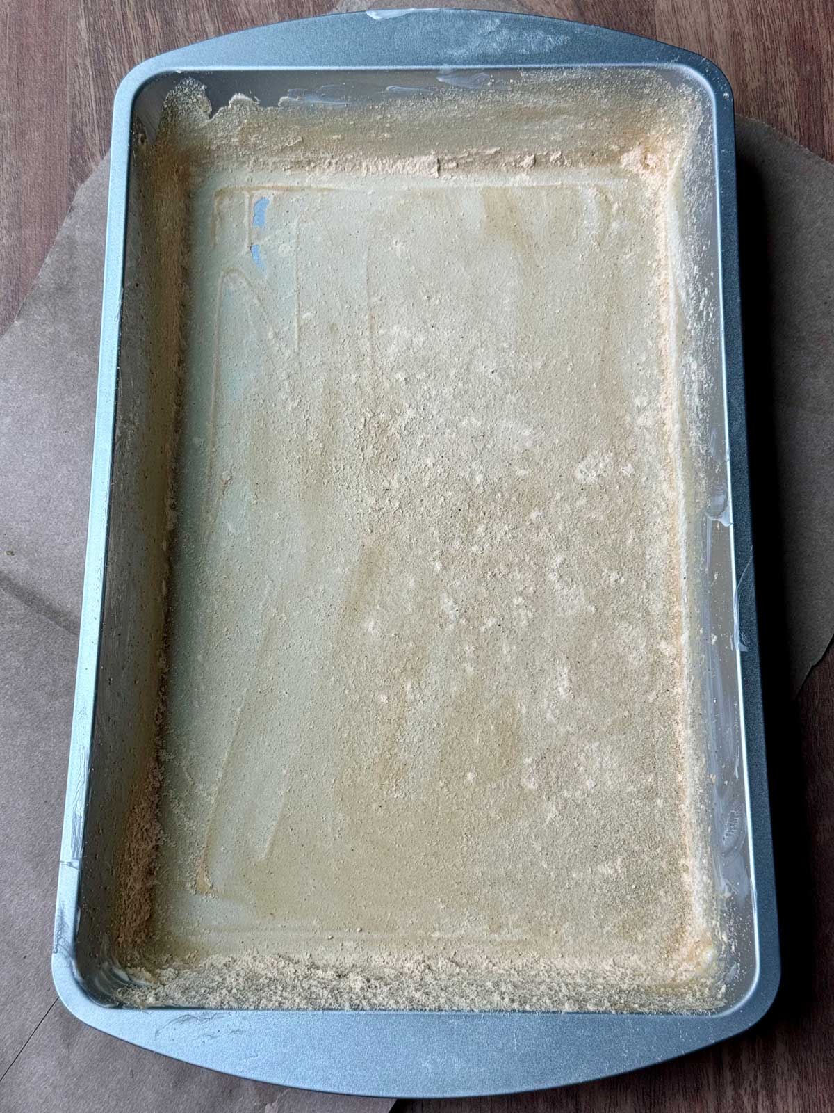 A 7x11 inch baking pan greased and dusted with peanut butter powder.