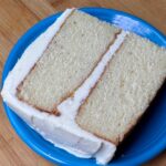 Slice of vanilla cake with buttercream vanilla frosting made without confectioners' sugar.