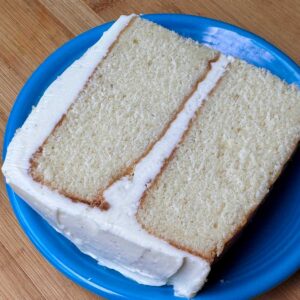 Slice of vanilla cake with buttercream vanilla frosting made without confectioners' sugar.
