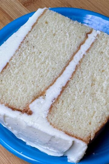 Slice of vanilla cake with buttercream vanilla frosting made without confectioners' sugar.
